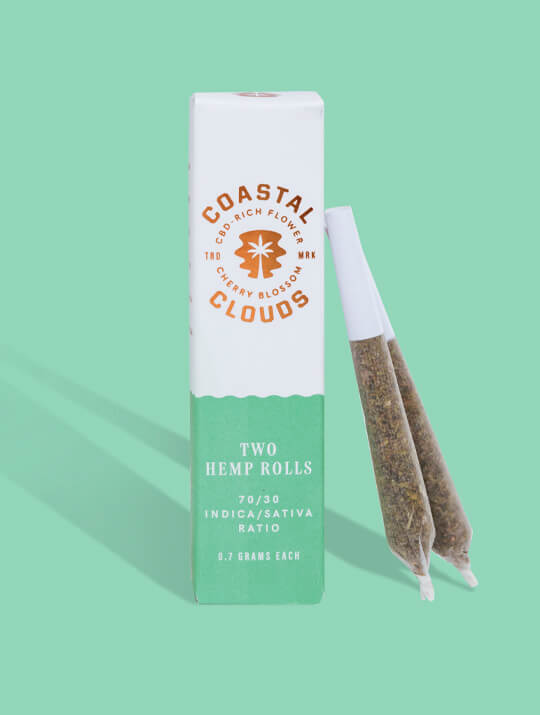 Picture of 2 Coastal Clouds CBD pre rolls leaning against box