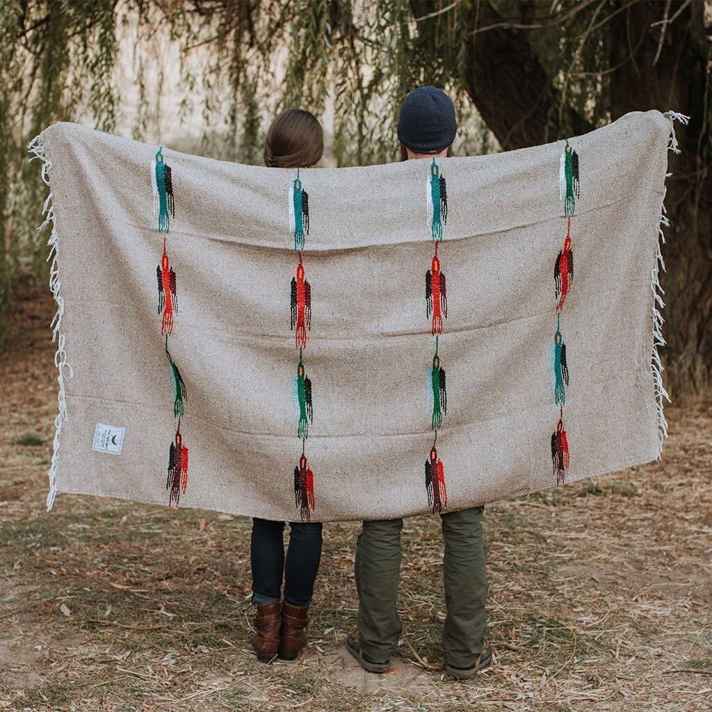 picture of man holding a tan blanket from trek light gear